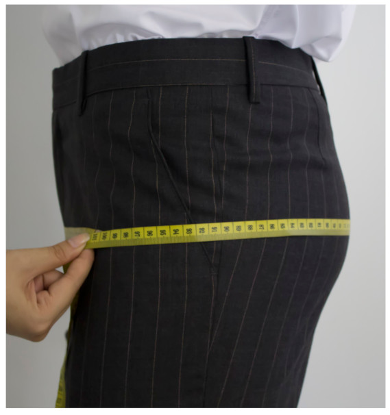 A person measuring their buttDescription automatically generated